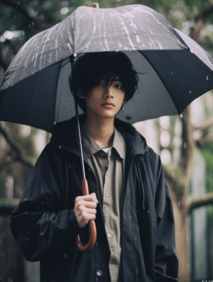 Asian Boy Standing with Umbrella in the Rain