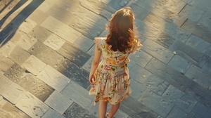 Kodak,Portra,160 8k Top view, medium shot, raw photo of a beautiful slender girl wears colorful summer dress walking on the plaza, pale and fairy skin, intricate skin texture, messy brown hair, flushing face, soft sunshine, light and shadow, high contrast,